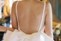 10 a gorgeous fitting wedding dress on straps, with an open back and an oversized bow for a lovely and chic look at your wedding