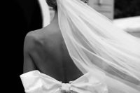 11 an adorable fitting wedding dress with an open back and a large bow plus a long veil for a dreamy and very romantic wedding look