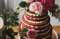 a beautiful naked red velvet wedding cake with pink and blush blooms, greenery and sugar pearls is a cool idea for a summer wedding