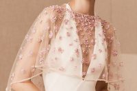 13 a super delicate sheer cover up with pink 3D flowers on is a cool and chic accessory for a bride