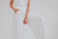 17 a 70s inspired bridal look with a white plain top with cap sleeves and wideleg pants with a train that remind of a skirt