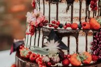 18 a gorgeous naked wedding cake with chocolate drip, fresh berries and blooms is a fantastic idea for a boho or rustic wedding in the fall