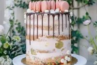 19 a naked cake with chocolate drip, meringues, pink macarons and gold leaf is a fresh and pretty idea for a cute spring wedding
