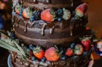 21 a naked chocolate wedding cake with chocolate drip, fresh berries and greenery is a gorgeous and delicious idea for any relaxed and laid-back wedding