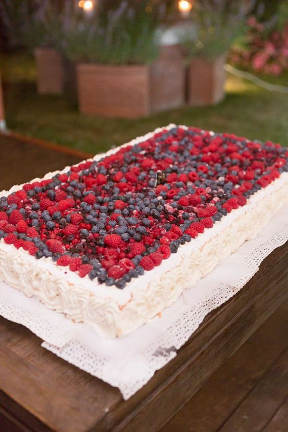 a large sheet wedding cake topped with fresh berries is a cool idea for a casual or just more relaxed summer wedding