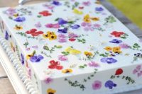 23 a white sheet wedding cake with colorful pressed flowers is a super cool idea for a spring or summer wedding