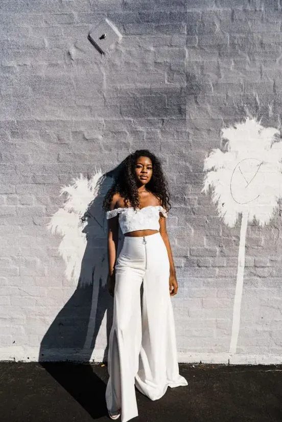 a sexy bridal separate with a lace off the shoulder crop top high waisted flare pants is wow