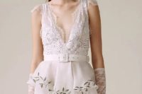 27 a lace and lace applique wedding dress with a V-neckline and cap sleeves, a peplum detail and long lace sleeves