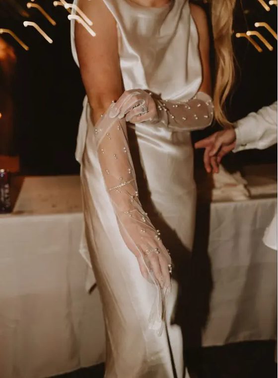 fantastic sheer tulle pearl wedding gloves are a nice match for a silk wedding dress, they will highlight its sophistication