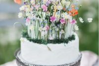 33 a fantastic wedding cake in white, with tiny colorful flowers, moss and foliage is a lovely idea for a secret garden wedding