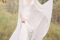 38 a minimalist bridal look with a slip silk maxi wedding dress with a train and a modern sheer capelet that accents the look and makes it wow