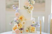 38 a white wedding cake with pastel blooms is a cool idea, fresh flowers instantly bring a fresh feel to the dessert table