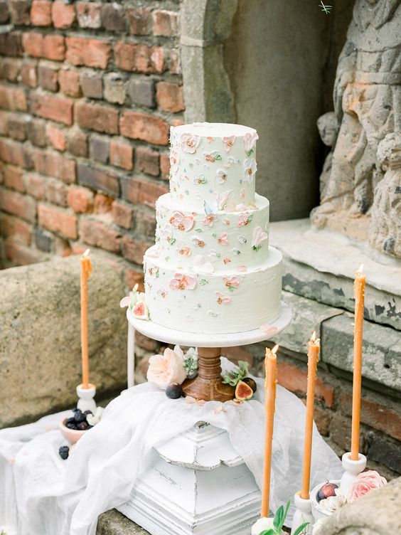 a white wedding cake with sugar white and pink flowers is a lovely idea for a summer or fall wedding