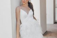 40 a mini wedding dress with a V-neckline and a feather skirt plus spaghetti straps is a lovely idea of a reception dress or playful mini dress