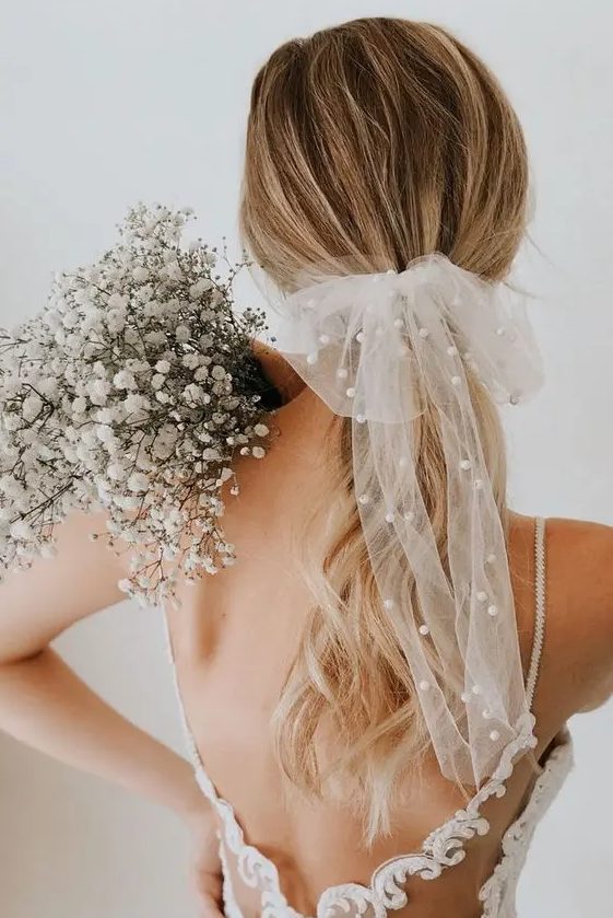 a beautiful sheer bow with pearls is a very trendy bridal accessory and a fresh way to wear pearls on your wedding day