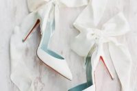 47 white wedding heels accented with oversized white ribbon bows are an amazing solution for a girlish and glam bridal look