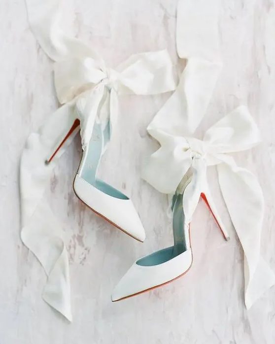 white wedding heels accented with oversized white ribbon bows are an amazing solution for a girlish and glam bridal look