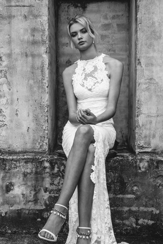 a chic lace halter neckline wedding dress with a front slit and a train for a boho or gypsy bride