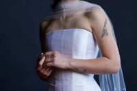 50 a refined modern bridal look with a strapless wedding dress and a sheer scarf with pearls all over