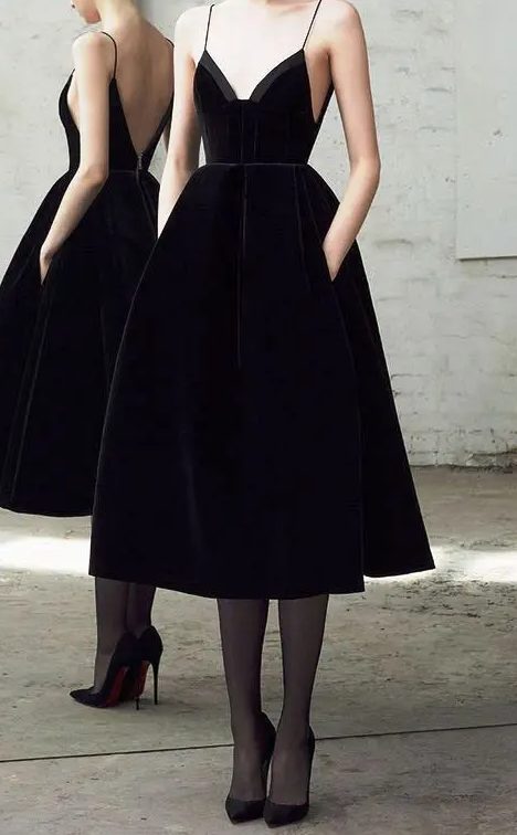 a gorgeous black velvet A-line midi bridesmaid dress with a deep neckline, an open back and a full skirt with pockets
