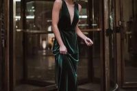 a non-traditional and very refined and elegant green velvet wedding dress with a plunging neckline, thick straps, an open back and a train