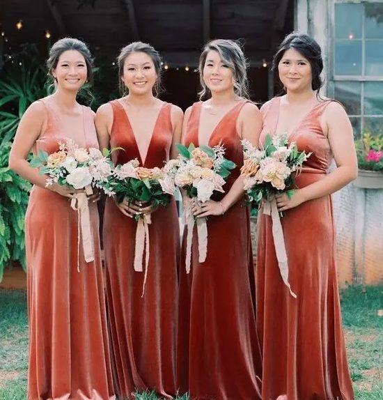beautiful matching bridesmaid dresses in pink, peachy, orange and rust velvet, with deep necklines and thick straps are gorgeous