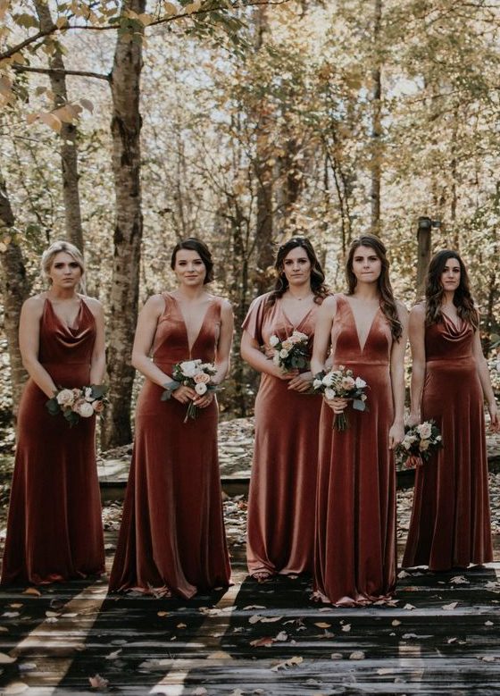 chic mismatching rust-colored velvet bridesmaid dresses with deep necklines will fit both a fall and a winter wedding