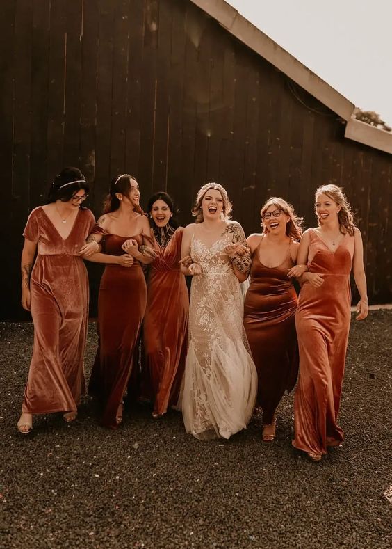mismatching brown, rust and burnt orange velvet maxi bridesmaid dresses are a great idea for a fall wedding