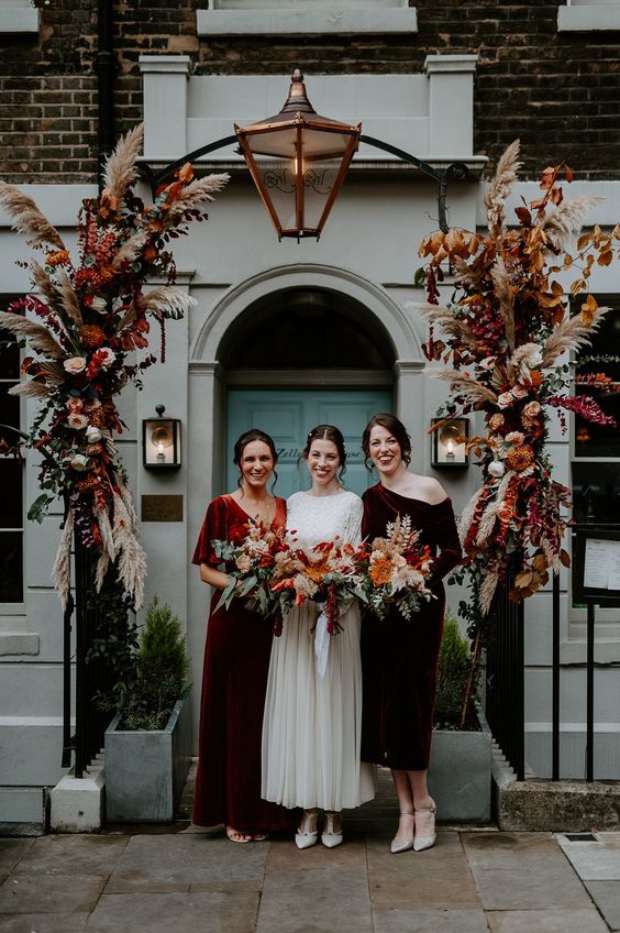 mismatching burgundy and rust-colored velvet bridesmaid dresses are awesome for a fall wedding