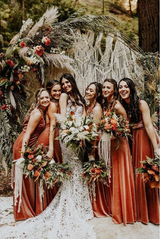 rust-colored velvet bridesmaid maxi dresses with mismatching necklaces are lovely for a boho wedding