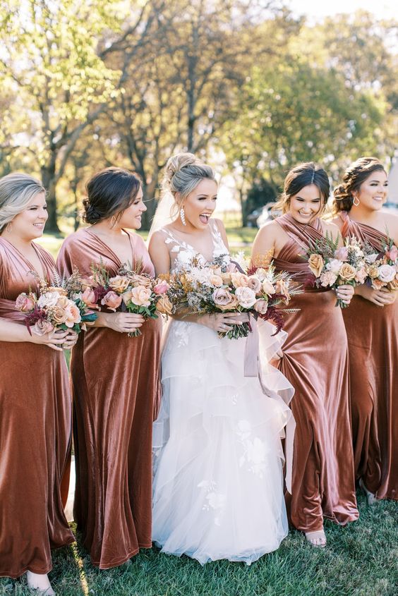 rust-colored velvet maxi bridesmaid dresses are great for a fall wedding, they look chic and catchy