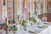05 a sophisticated wedding tablescape with refined vintage candleholders, pastel blooms and greenery and white and blue porcelain