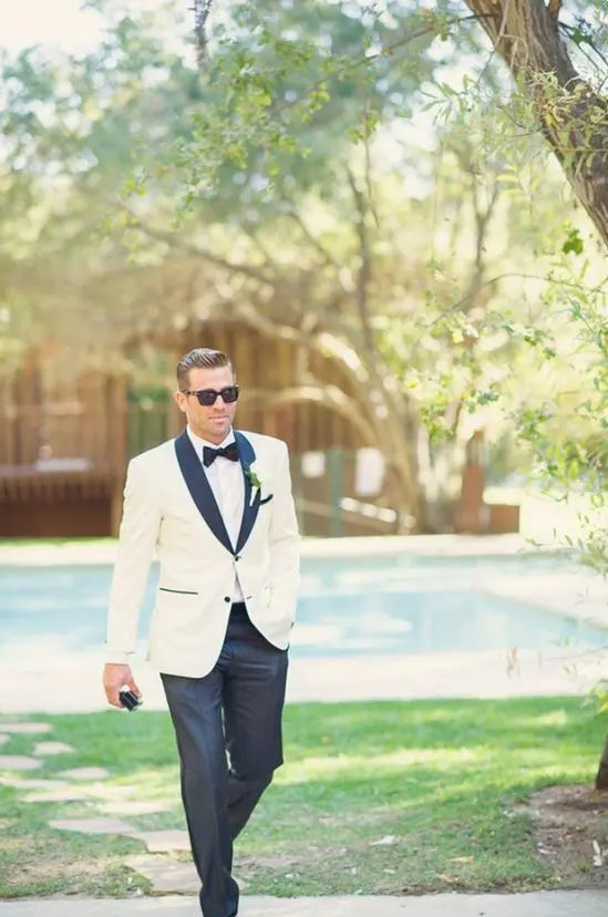 a modern take on a white tuxedo look with black lapels and touches for a cool feel