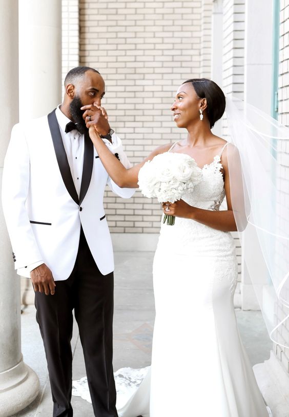 a chic black and white tux with black details, a white shirt, a black bow tie and black pants for a glam and refined wedding
