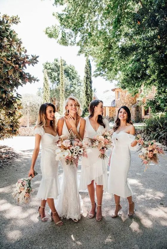 mismatching midi white bridesmaid dresses and nude shoes are a timeless combo for a wedding done in neutral shades