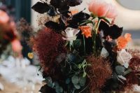 20 a boo lux wedding centerpiece of green and dark foliage, pink and blush blooms and smokebush