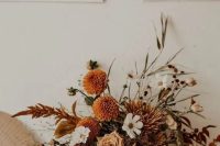 21 a beautiful boho fall wedding centerpiece of white, rust, neutral blooms, bold foliage, greenery is a very refined idea to rock