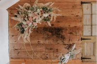 23 a boho celestial wedding altar of a metal half moon, white and blush blooms, greenery and pampas grass and pillar candles