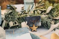 26 a celestial wedding tablescape with gold placemats, grey porcelain and grey watercolor stationery, gold stars and greenery