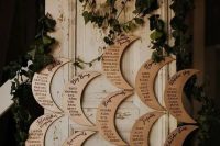28 a moon shaped seating chart decorated with greenery is a cool idea for a celestial wedding
