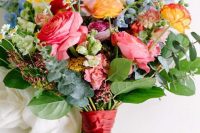 36 a bright summer wedding bouquet with pink, yellow, purple and blue flowers and greenery for a refined summer wedding