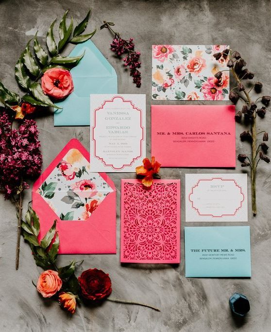a bright wedding invitation suite in pink, light blue and with floral prints and laser cut is amazing and fun