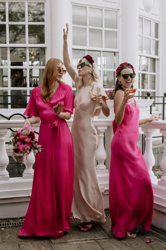 mismatching bright pink maxi bridesmaid dresses are a nice solution for a bold wedding with pinks