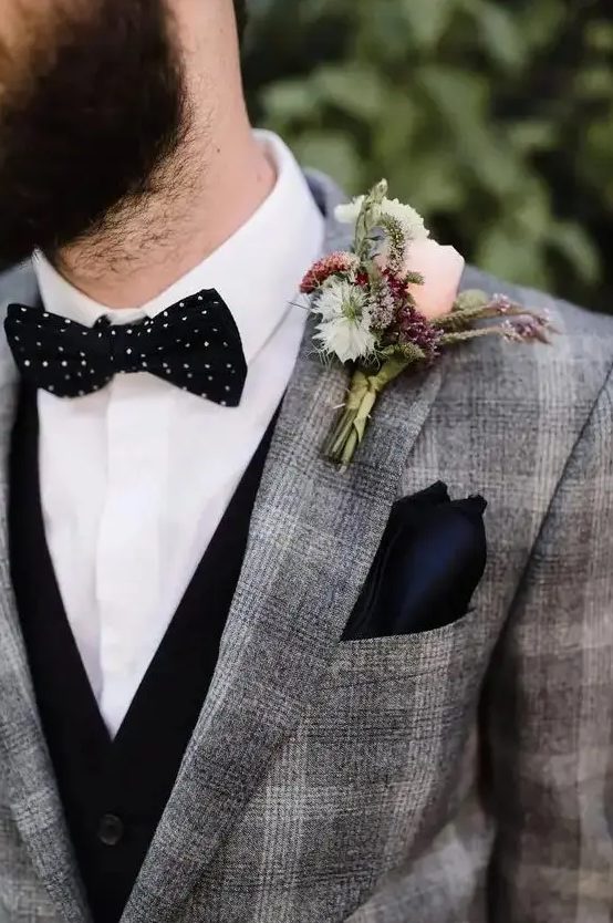 a grey plaid pantsuit with a black waistcoat, a white shirt, a black polka dot bow tie and a black handkerchief are a super stylish combo