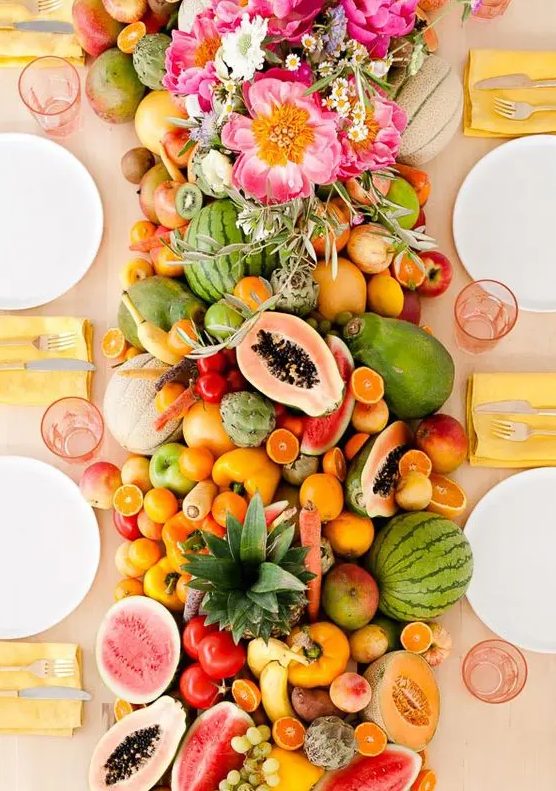 a super lush table runner of every kind of tropical fruit wows and can be eaten by the guests