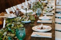 53 a pretty neutral wedding tablescape with patterned plates, candles, greenery, green and grey glasses