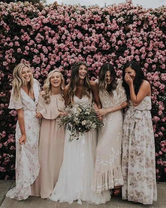 bridesmaids in mismatched floral maxi dresses and in blush ones for a tender and subtle combo
