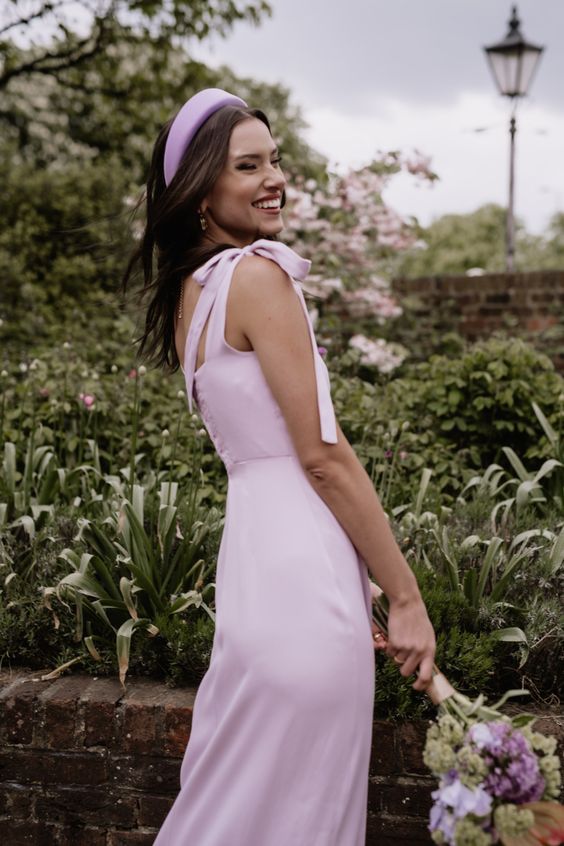 a light pink plain maxi bridesmaid dress with bows on the shoulders and a matching headband are cool for spring