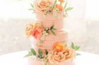 a Peach Fuzz wedding cake decorated with ornage and peachy roses, greenery and a sign topper is a lovely idea