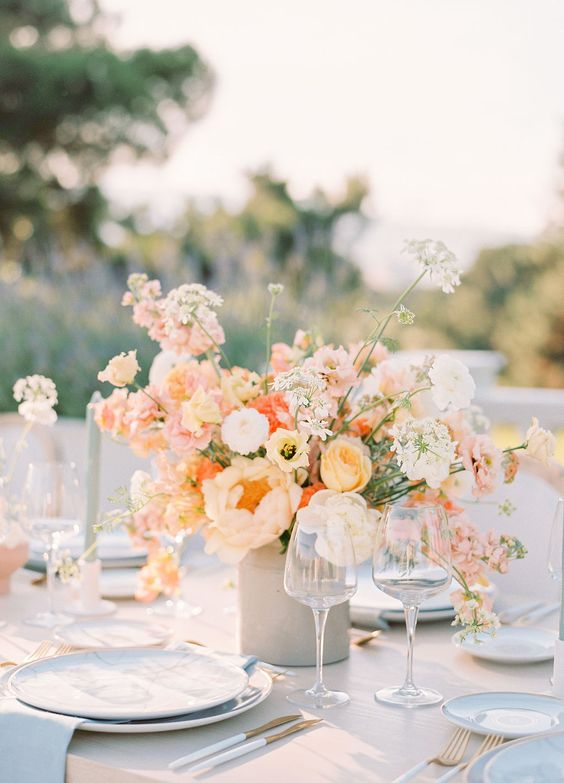 a beautiful peachy wedding centerpiece of peachy, yellow, white blooms is a lovely and catchy idea to rock